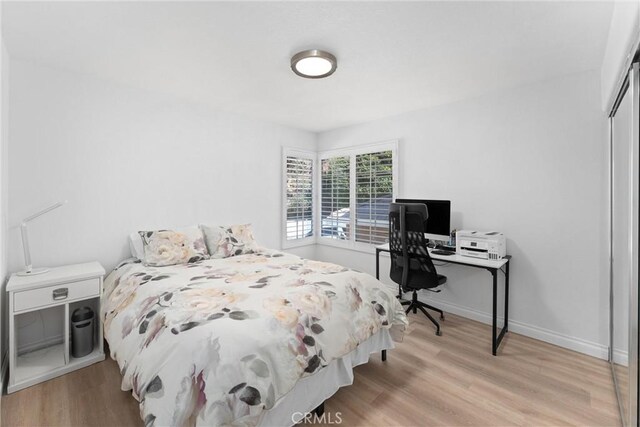 1720 San Alvarado Cir, Corona, CA 92882 - bedroom with light wood-style flooring, a closet, and baseboards