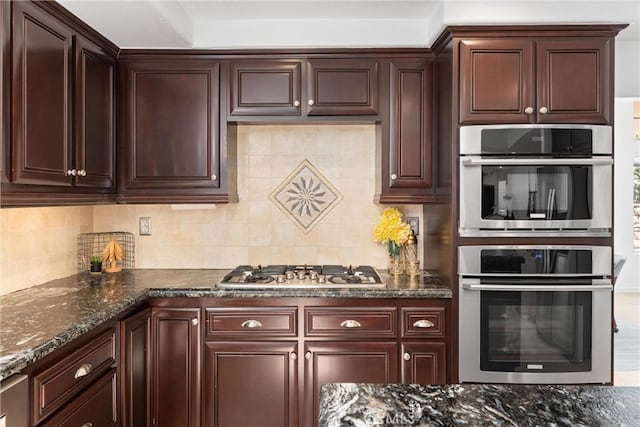1720 San Alvarado Cir, Corona, CA 92882 - kitchen with appliances with stainless steel finishes, backsplash, dark stone countertops, and dark brown cabinets