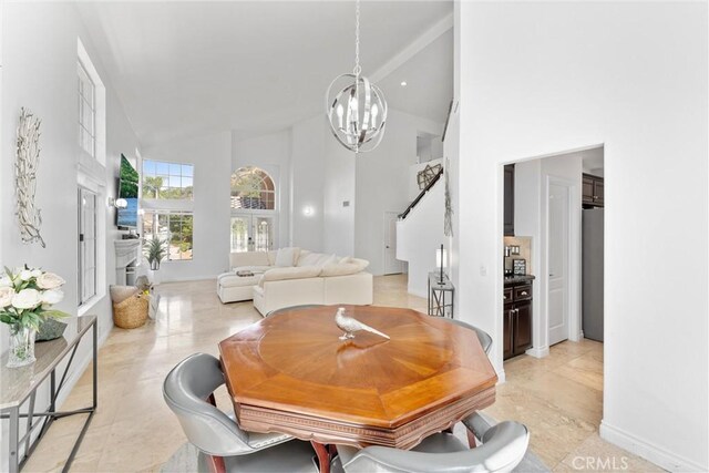 1720 San Alvarado Cir, Corona, CA 92882 - dining space with a high ceiling, a chandelier, and light tile patterned floors