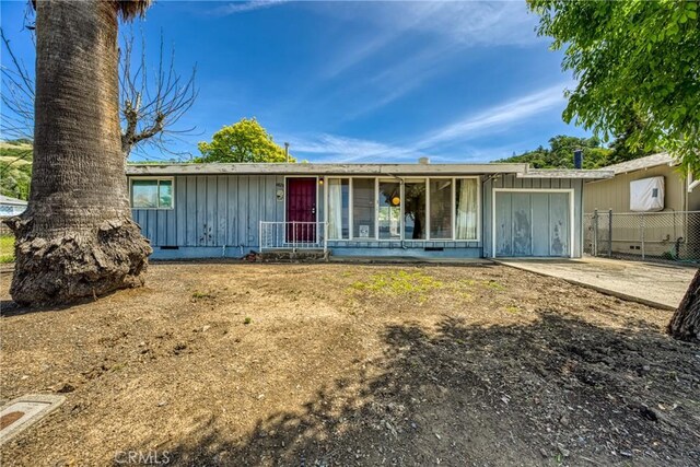 6828 Frontage Rd, Lucerne, CA 95458 - ranch-style home featuring fence and board and batten siding