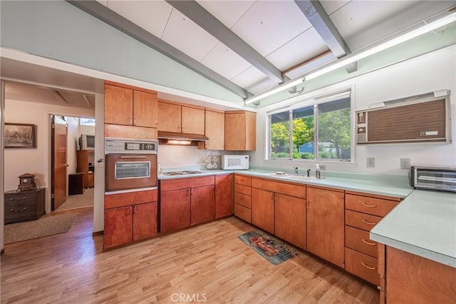 6828 Frontage Rd, Lucerne, CA 95458 - kitchen with wall oven, white microwave, vaulted ceiling with beams, light countertops, and a sink