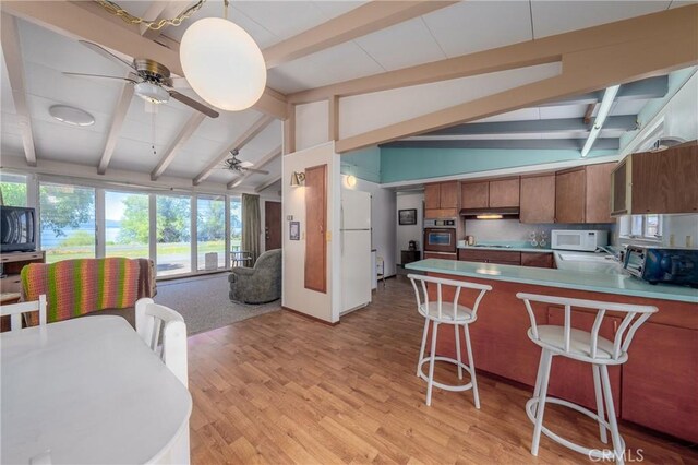 6828 Frontage Rd, Lucerne, CA 95458 - kitchen featuring white appliances, open floor plan, lofted ceiling with beams, under cabinet range hood, and a ceiling fan