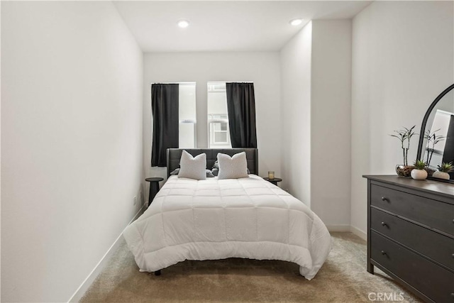 bedroom featuring baseboards, recessed lighting, and light carpet