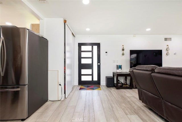 foyer featuring visible vents, recessed lighting, and light wood-style flooring