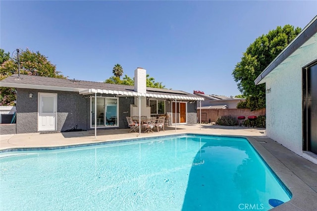 pool featuring fence and a patio area