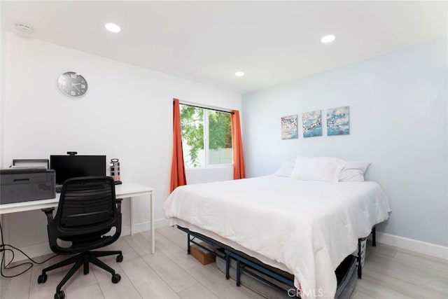 bedroom featuring light wood-type flooring, recessed lighting, and baseboards