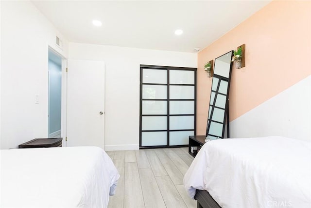 bedroom featuring light wood finished floors, recessed lighting, and visible vents