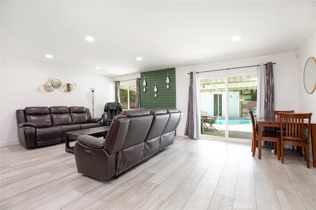 living area featuring recessed lighting, baseboards, and light wood-style floors