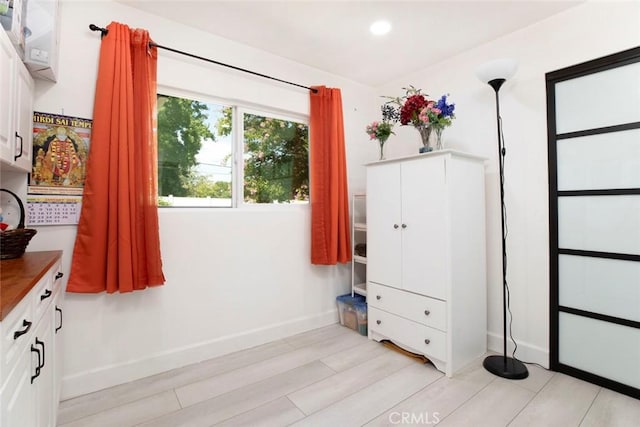 interior space featuring baseboards, recessed lighting, and light wood-style flooring