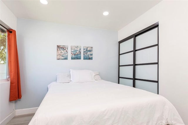 bedroom with recessed lighting, baseboards, and light wood-style flooring