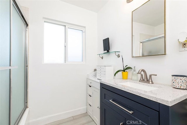 full bath with vanity, baseboards, and wood finished floors