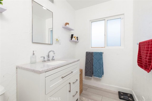 bathroom featuring vanity and baseboards
