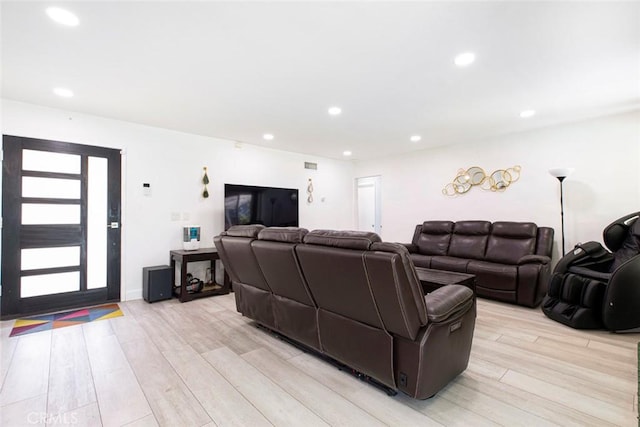 living area featuring light wood-style floors, recessed lighting, and visible vents