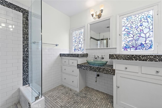 336 Marwood Ave, Fullerton, CA 92832 - bathroom featuring a sink, tile walls, tiled shower, healthy amount of natural light, and a wainscoted wall