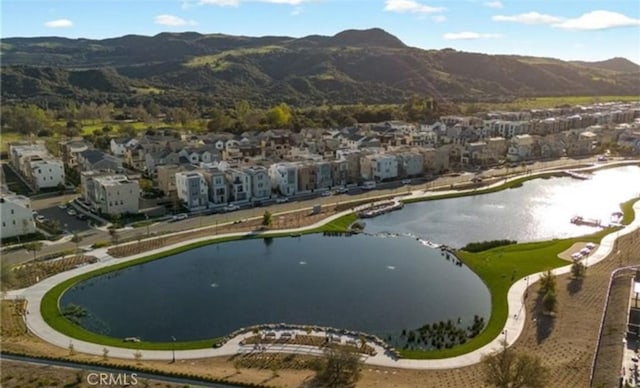 aerial view with a water and mountain view and a residential view