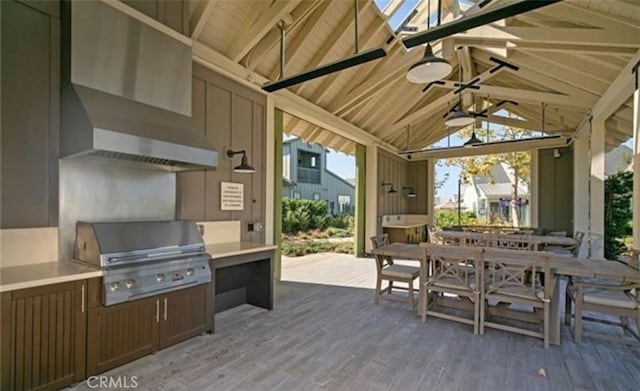 view of patio with a ceiling fan, exterior kitchen, a gazebo, outdoor dining space, and a grill