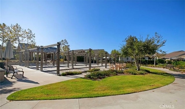 surrounding community featuring a yard and a pergola