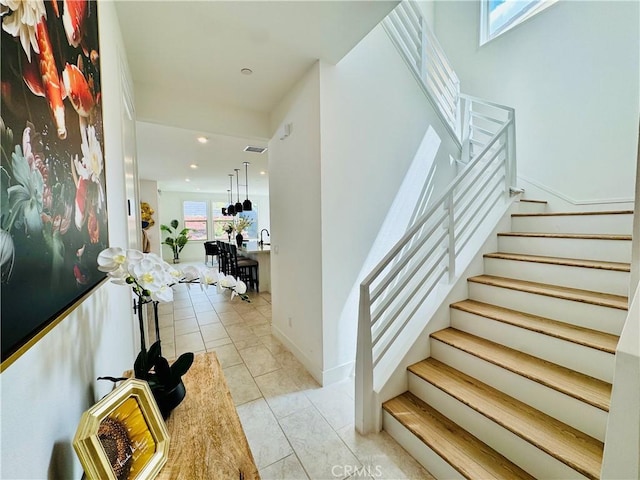 stairway featuring visible vents and recessed lighting