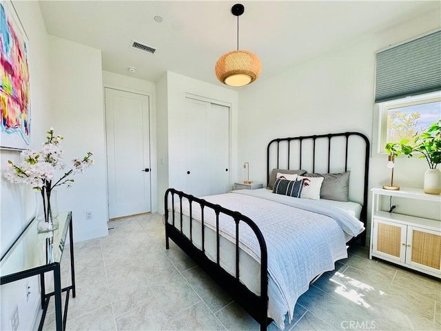 bedroom featuring visible vents and a closet