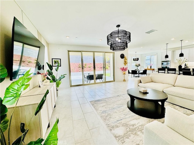 living room featuring recessed lighting, visible vents, and light tile patterned floors
