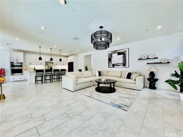 living area with recessed lighting, a notable chandelier, and visible vents