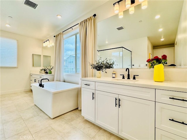 bathroom with visible vents, tile patterned flooring, a freestanding bath, and a shower stall