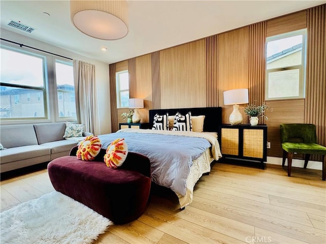 bedroom featuring visible vents and light wood-style flooring
