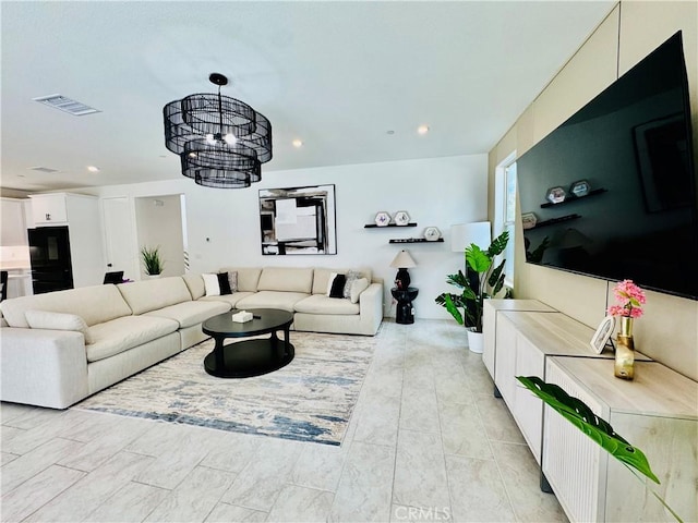 living area with a notable chandelier, recessed lighting, and visible vents