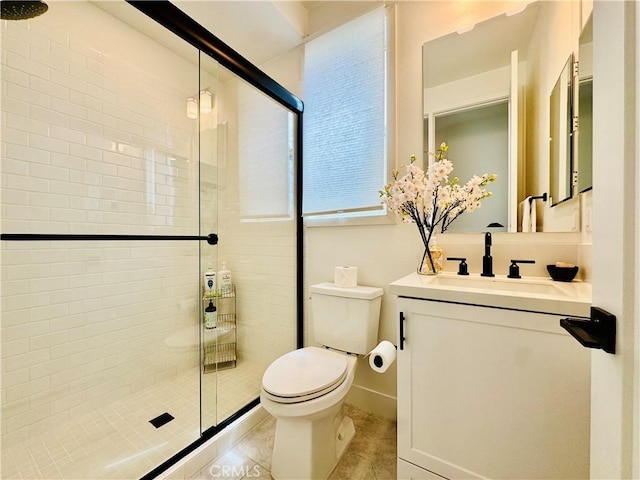 bathroom with vanity, tile patterned flooring, toilet, and a shower stall