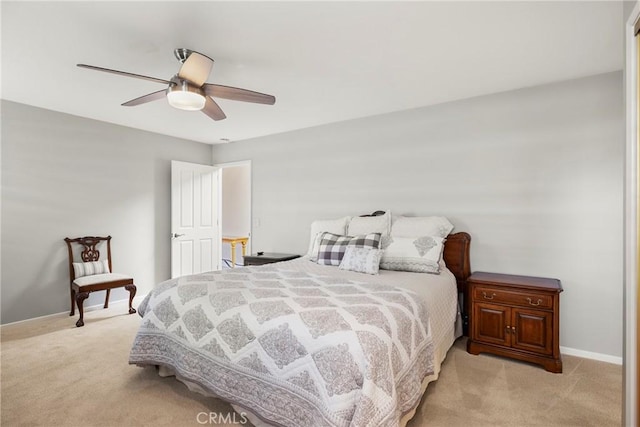 bedroom with light colored carpet, a ceiling fan, and baseboards