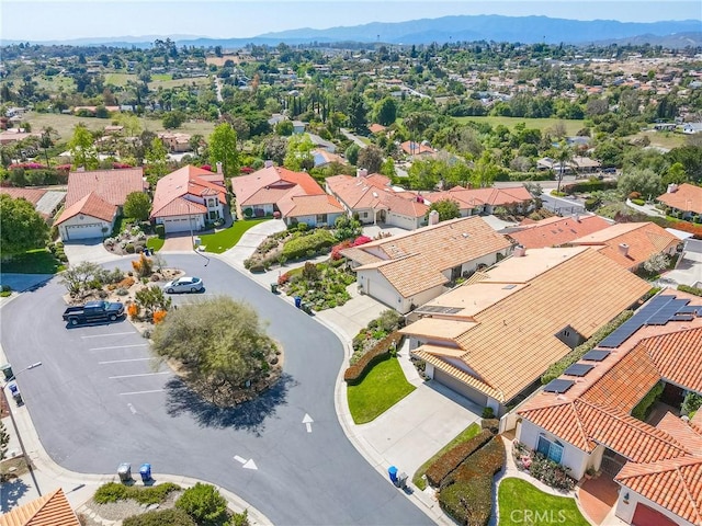 birds eye view of property with a mountain view and a residential view