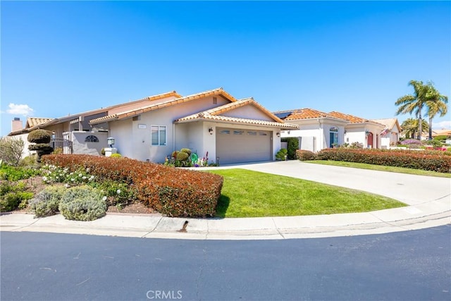 view of front facade featuring a garage, a front lawn, stucco siding, a tiled roof, and driveway