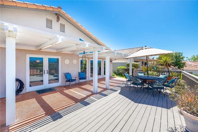 wooden deck featuring french doors and a pergola