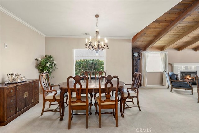 dining room featuring plenty of natural light, light carpet, visible vents, and a notable chandelier