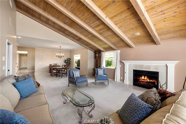 living room with beamed ceiling, baseboards, a chandelier, wooden ceiling, and a tile fireplace