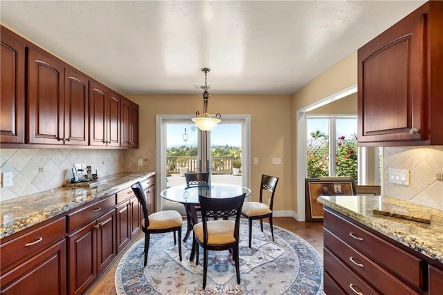 dining room featuring baseboards and wood finished floors