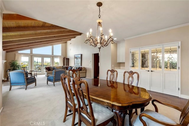 dining space featuring lofted ceiling with beams and a notable chandelier