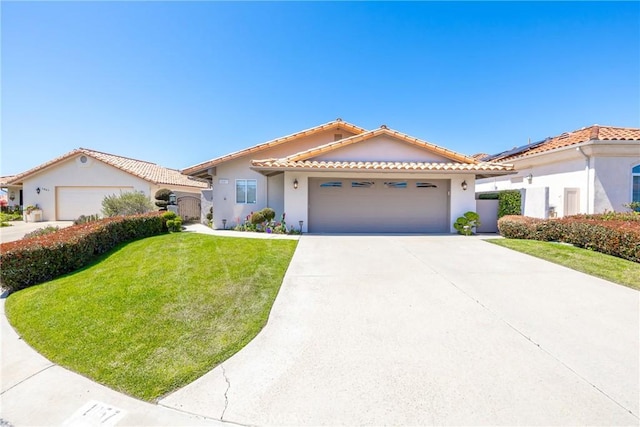 view of front facade with a garage, stucco siding, a front yard, a tiled roof, and driveway