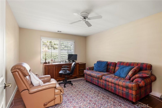 office featuring baseboards, a ceiling fan, and wood finished floors