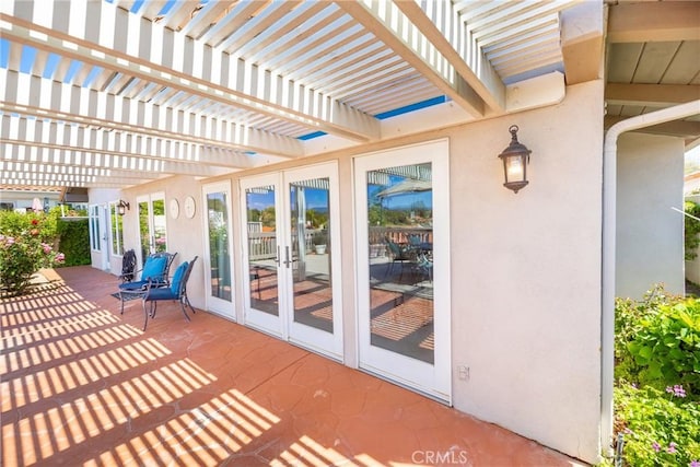 view of patio / terrace featuring french doors and a pergola