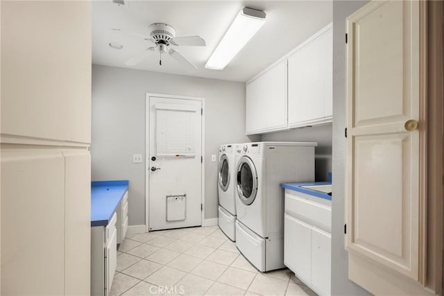 laundry room featuring a ceiling fan, cabinet space, baseboards, separate washer and dryer, and light tile patterned flooring