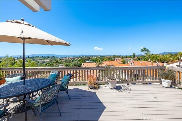 wooden deck featuring outdoor dining area