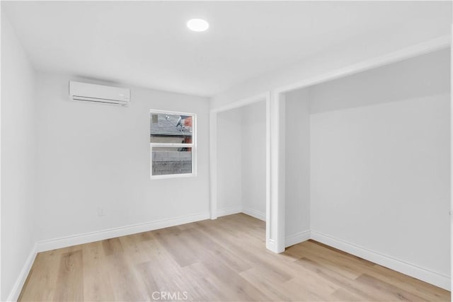 7307 Diamond St, Riverside, CA 92504 - spare room featuring baseboards, light wood finished floors, and a wall unit AC