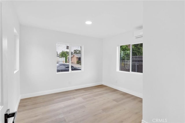 7307 Diamond St, Riverside, CA 92504 - spare room featuring baseboards, a wall mounted air conditioner, recessed lighting, and wood finished floors