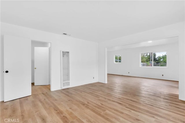 7307 Diamond St, Riverside, CA 92504 - empty room featuring a heating unit, light wood-style floors, and visible vents