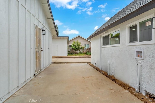7307 Diamond St, Riverside, CA 92504 - view of side of property featuring a patio area, stucco siding, and board and batten siding