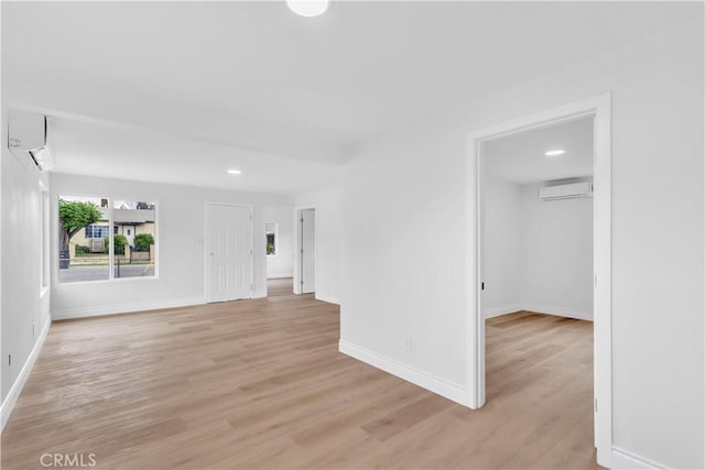 7307 Diamond St, Riverside, CA 92504 - interior space with light wood-style flooring, baseboards, a wall unit AC, and recessed lighting
