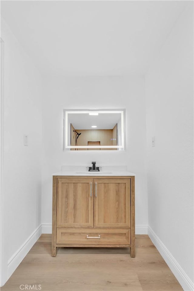 7307 Diamond St, Riverside, CA 92504 - details featuring baseboards, vanity, and wood finished floors