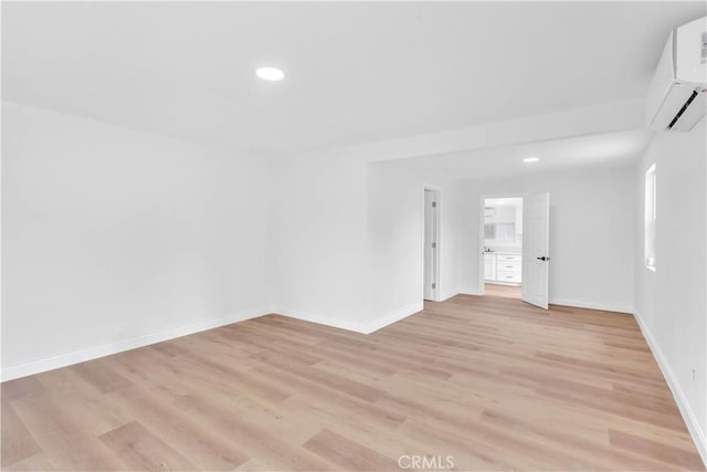 7307 Diamond St, Riverside, CA 92504 - spare room featuring light wood finished floors, recessed lighting, baseboards, and an AC wall unit