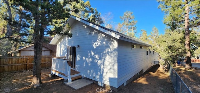 view of side of home featuring fence
